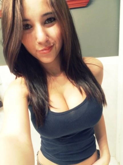 Picture of Amateur brunette teen down top shot showing cleavage 